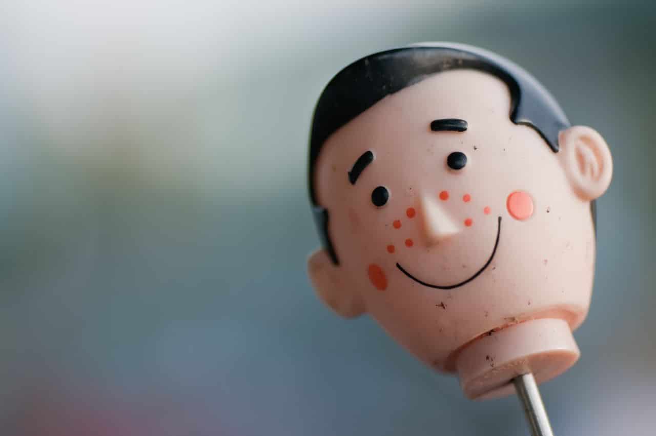 Detailed macro shot of a smiling cartoon face toy with a cheerful expression.